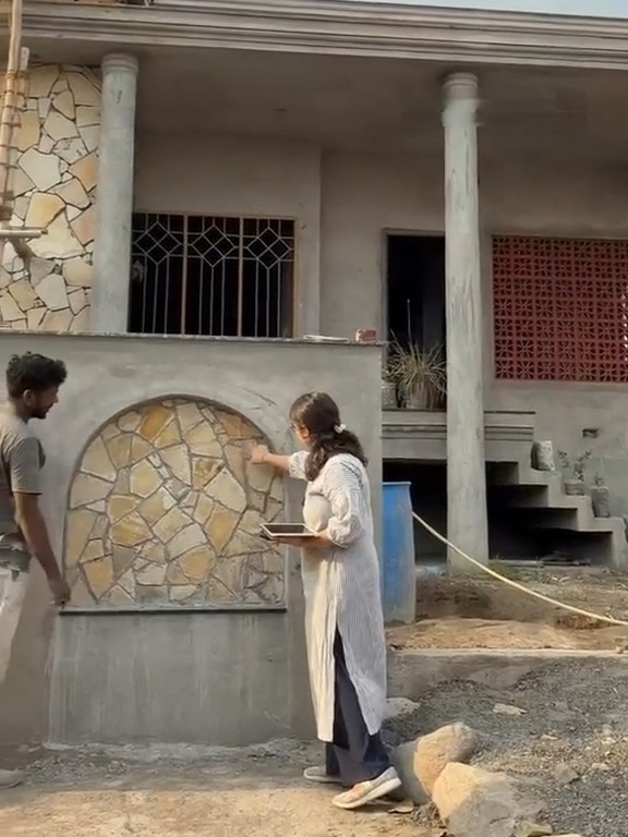 The architect checking stonework with a mason